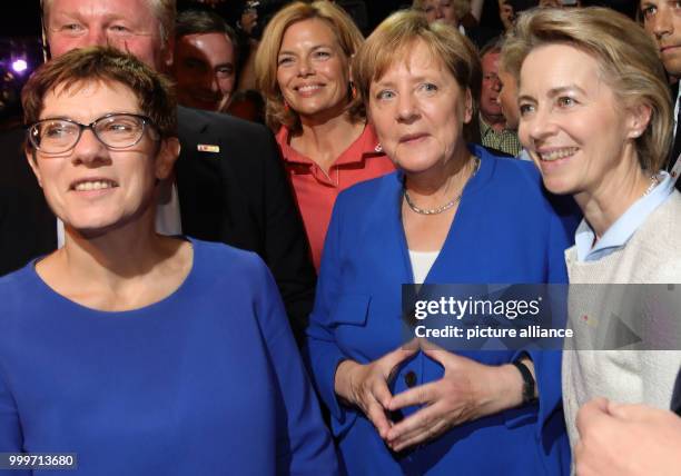 Chancellor Angela Merkel stands next to the Prime Minister of Saarland Annegret Kramp-Karrenbauer , the chairmwoman of the CDU in...