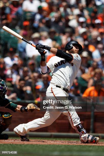 Brandon Crawford of the San Francisco Giants hits a double against the Oakland Athletics during the second inning at AT&T Park on July 15, 2018 in...