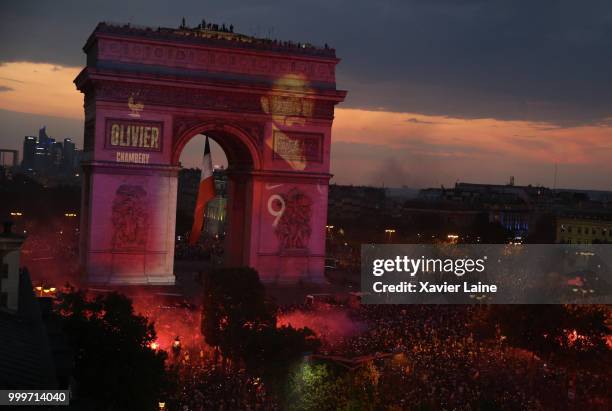 Olivier Giroud is projected on the Arc de Triomphe des champs elysee as fans celebrate France’s victory over Croatia in the 2018 FIFA World Cup final...