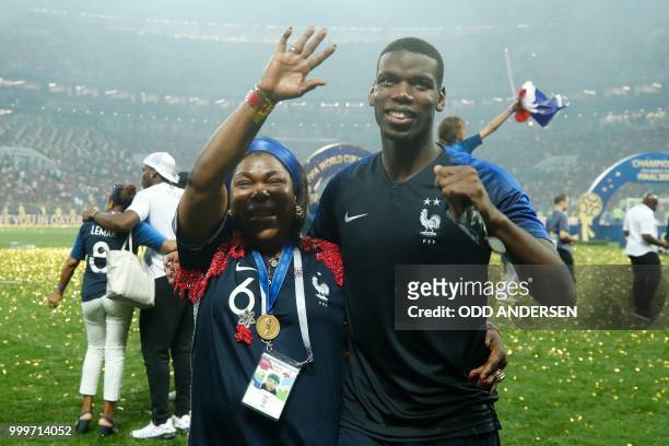 France's midfielder Paul Pogba celebrates with his mother after the World Cup trophy after the Russia 2018 World Cup final football match between...