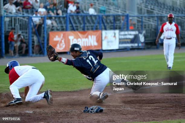 Takashi Umino of Japan made double play in front of Dainier Galvez Guerra of Cuba in the 3rd inning during the Haarlem Baseball Week game between...