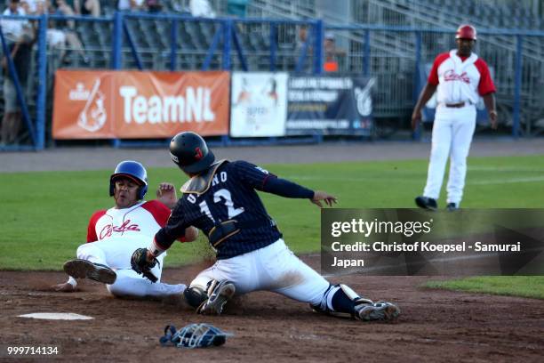 Takashi Umino of Japan made double play in front of Dainier Galvez Guerra of Cuba in the 3rd inning during the Haarlem Baseball Week game between...