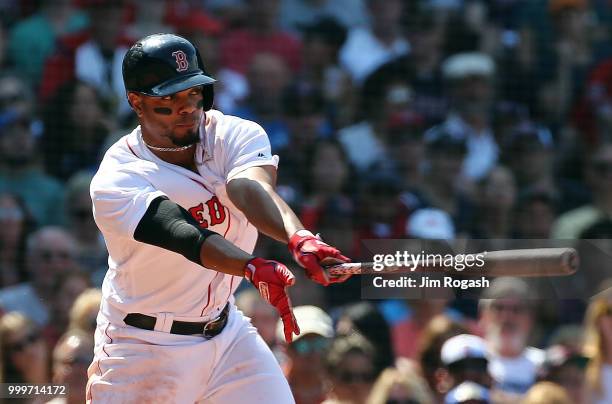 Xander Bogaerts of the Boston Red Sox attempts to make contact in the event inning against the Toronto Blue Jays at Fenway Park on July 15, 2018 in...