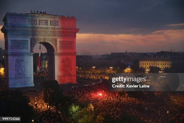 The French flag and Fiers D'etre Bleus in reference to the French national team's nickname Les Bleus is projected onto the Arc de Triomphe as fans...