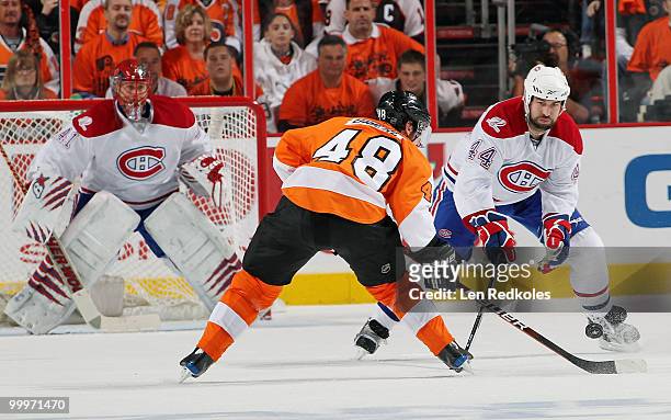Jaroslav Halak and Roman Hamrlik of the Montreal Canadiens defend against the attack of Danny Briere of the Philadelphia Flyers in Game Two of the...