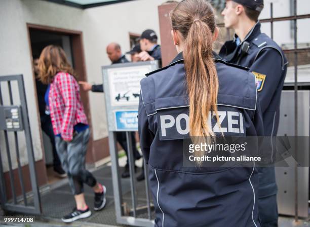 Resident leaves her home after several police officers forcedly evacuated her at Hermann Street in Frankfurt am Main, Germany, 3 September 2017. Up...