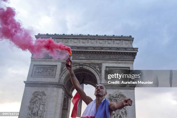 French fans gather at the Arc de Triomphe to celebrate France's victory over Croatia 4-2 in the 2018 FIFA World Cup final on July 15, 2018 in Paris,...