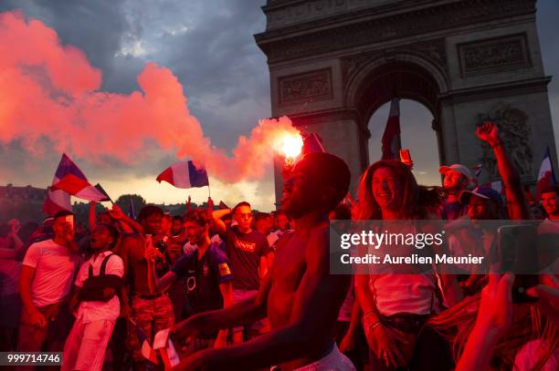 French fans gather at the Arc de Triomphe to celebrate France's victory over Croatia 4-2 in the 2018 FIFA World Cup final on July 15, 2018 in Paris,...