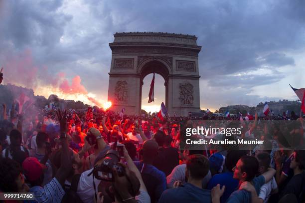 French fans gather at the Arc de Triomphe to celebrate France's victory over Croatia 4-2 in the 2018 FIFA World Cup final on July 15, 2018 in Paris,...