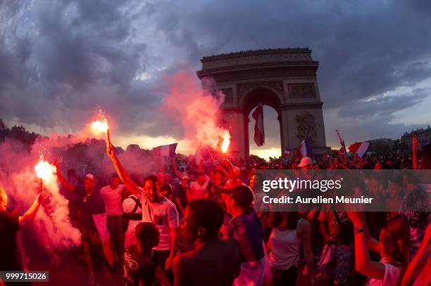 French fans gather at the Arc de Triomphe to celebrate France's victory over Croatia 4-2 in the 2018 FIFA World Cup final on July 15, 2018 in Paris,...