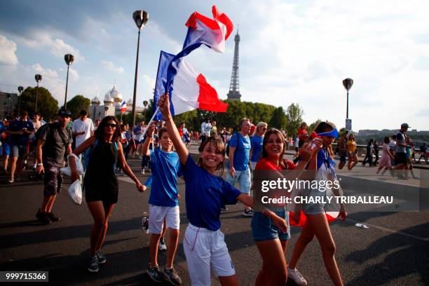 France supporters celebrate as they leave the fan zone on the Champ de Mars in Paris on July 15 after France won the Russia 2018 World Cup final...