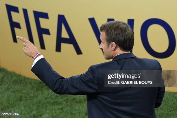 French President Emmanuel Macron gestures at the end of the Russia 2018 World Cup final football match between France and Croatia at the Luzhniki...