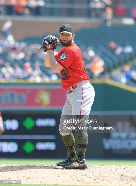 Cam Bedrosian of the Los Angeles Angels of Anaheim pitches while wearing a special jersey, hat, shoes and socks to honor Memorial Day during the game...