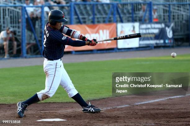 Takashi Umino of Japan hits the ball in the forth inning and scores the third point during the Haarlem Baseball Week game between Cuba and Japan at...
