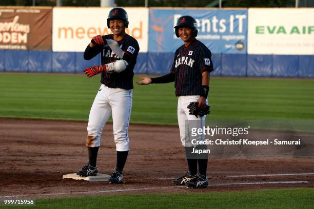Toshiya Sato of Japan and Daigo Kamikawabata of Japan celebrate spring the third point in the 4th inning during the Haarlem Baseball Week game...