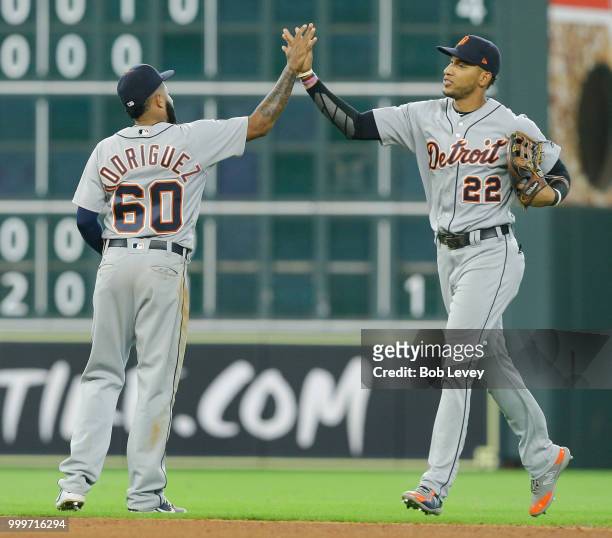 Ronny Rodriguez of the Detroit Tigers high fives Victor Reyes after the final out against the Houston Astros at Minute Maid Park on July 15, 2018 in...