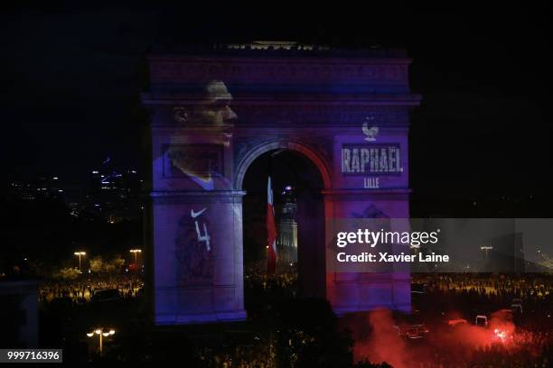 Raphael Varane is projected on the Arc de Triomphe des champs elysee as fans celebrate France’s victory over Croatia in the 2018 FIFA World Cup final...