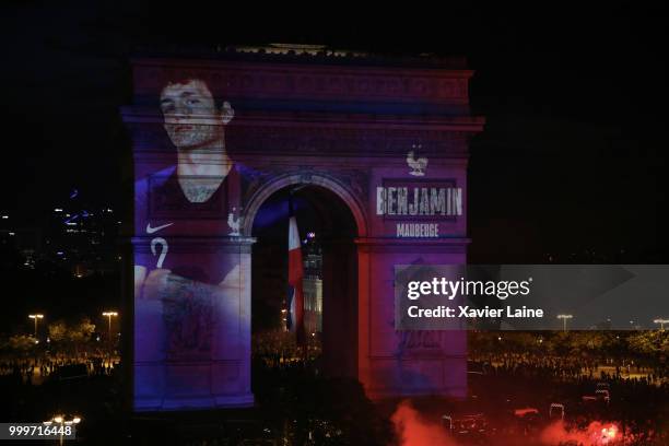 Benjamin Pavard is projected on the Arc de Triomphe des champs elysee as fans celebrate France’s victory over Croatia in the 2018 FIFA World Cup...