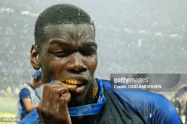 France's midfielder Paul Pogba celebrates with his medal after the Russia 2018 World Cup final football match between France and Croatia at the...