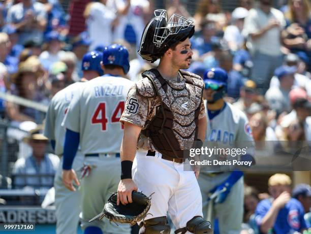 Austin Hedges of the San Diego Padres reacts as two runs score during the second inning of a baseball game against the Chicago Cubs at PETCO Park on...