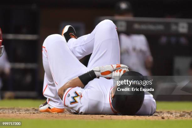 Derek Dietrich of the Miami Marlins lies on the ground after being hit by a pitch in the eighth inning against the Philadelphia Phillies at Marlins...