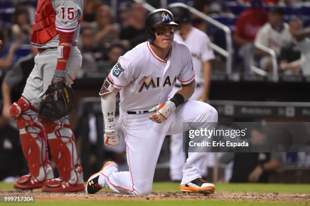 Derek Dietrich of the Miami Marlins walks towards first base after being hit by a pitch in the eighth inning against the Philadelphia Phillies at...