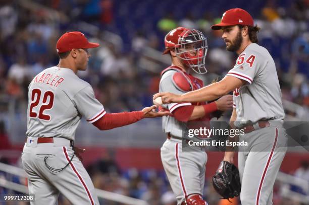 Gabe Kapler of the Philadelphia Phillies takes the baseball from Austin Davis during a pitching change in the eighth inning of the game against the...