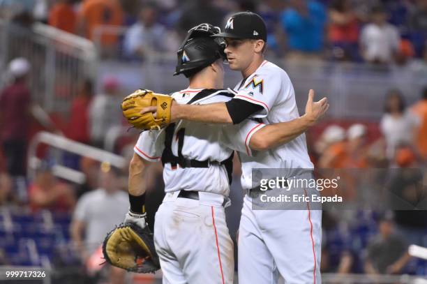 Ben Meyer of the Miami Marlins hugs J.T. Realmuto after defeating the Philadelphia Phillies at Marlins Park on July 15, 2018 in Miami, Florida.