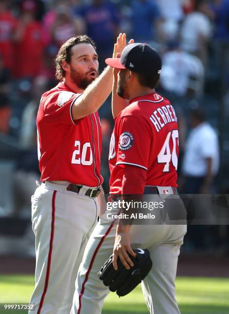 Daniel Murphy and Kelvin Herrera of the Washington Nationals celebrate a 6-1 win against the New York Mets during their game at Citi Field on July...