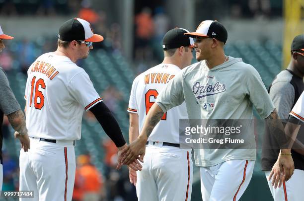 Manny Machado of the Baltimore Orioles celebrates with Trey Mancini after a 6-5 victory against the at Texas Rangers Oriole Park at Camden Yards on...