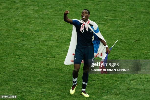 France's midfielder Paul Pogba celebrates after winning at the end of the Russia 2018 World Cup final football match between France and Croatia at...
