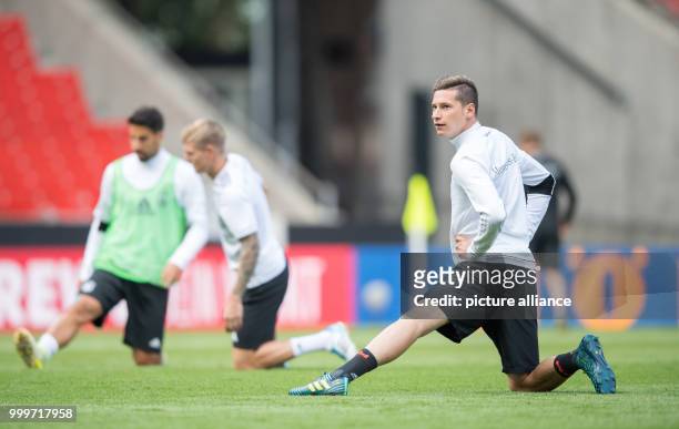 Germany's Julian Draxler stretches during a training session in the Mercedes-Benz Arena in Stuttgart, Germany, 03 September 2017. Germany will play...