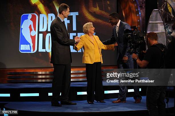 New Jersey Nets owner Mikhail Prokhorov and Jrue Holiday of the Philadelphia 76ers congratulates Irene Pollin, owner of the Washington Wizards during...