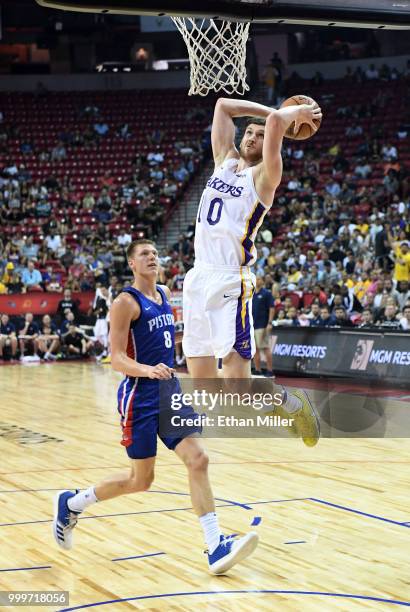 Sviatoslav Mykhailiuk of the Los Angeles Lakers dunks ahead of Henry Ellenson of the Detroit Pistons during a quarterfinal game of the 2018 NBA...