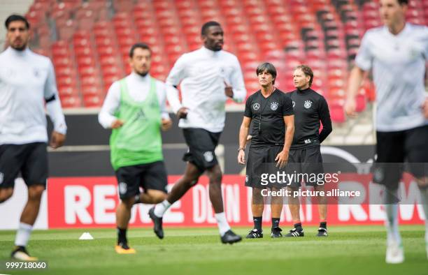 Germany's coach Joachim Loew watches his players during a training session in the Mercedes-Benz Arena in Stuttgart, Germany, 03 September 2017....