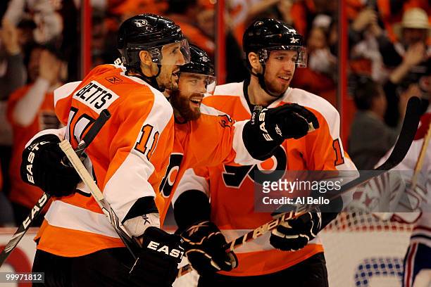 Ville Leino of the Philadelphia Flyers celebrates with teammates Blair Betts and Andreas Nodl after scoring a goal in the third period against the...