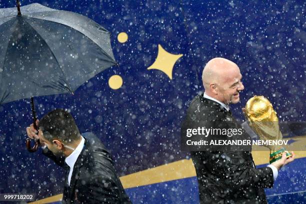 President Gianni Infantino holds the trophy during the trophy ceremony after winning the end of the Russia 2018 World Cup final football match...