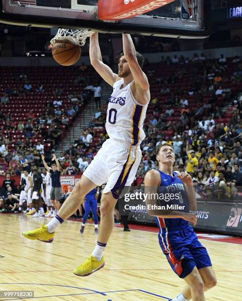 Sviatoslav Mykhailiuk of the Los Angeles Lakers dunks ahead of Henry Ellenson of the Detroit Pistons during a quarterfinal game of the 2018 NBA...