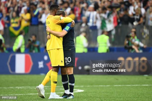 France's goalkeeper Steve Mandanda celebrates with France's forward Florian Thauvin after winning the Russia 2018 World Cup final football match...