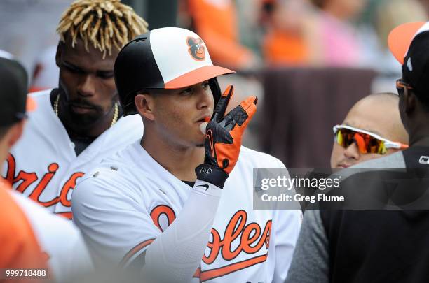 Manny Machado of the Baltimore Orioles celebrates with teammates after hitting a home run in the first inning against the Texas Rangers at Oriole...