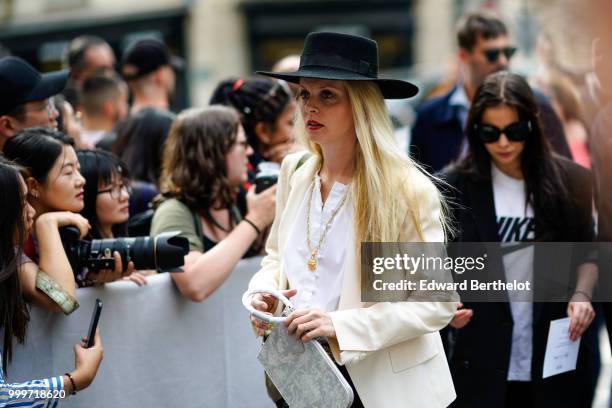 Guest wears a black hat and a white blazer jacket, outside Dior, during Paris Fashion Week - Menswear Spring-Summer 2019, on June 23, 2018 in Paris,...