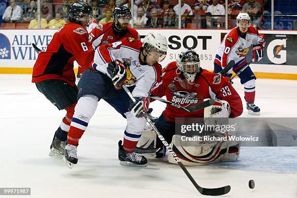 Gabriel Bourque of the Moncton Wildcats picks up the rebouding puck in front of Philip Grubauer of the Windsor Spitfires during the 2010 Mastercard...