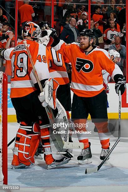 Michael Leighton and Claude Giroux of the Philadelphia Flyers react after defeating the Montreal Canadiens by a score of 3-0 to win Game 2 of the...