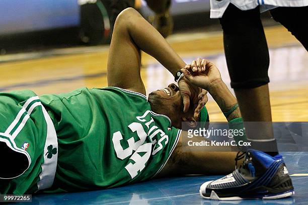 Paul Pierce of the Boston Celtics lies on the court in pain after he drew contact from Dwight Howard of the Orlando Magic in the second quarter of...