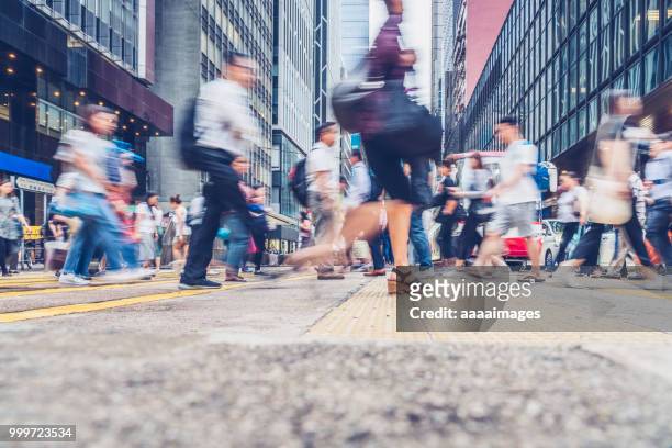 side view of pedestrains rush in hong kong - crowd of people walking stock pictures, royalty-free photos & images