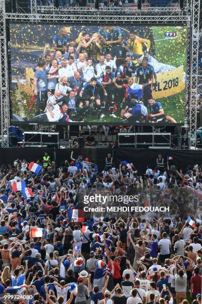 People celebrate France's victory in the Russia 2018 World Cup final football match between France and Croatia, on July 15, 2018 at the Chaban Delmas...