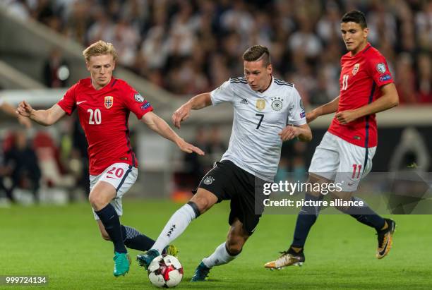 Germany's Julian Draxler and Norway's Haitam Aleesami and Mohamed Elyounoussi vie for the ball during the soccer World Cup qualification group stage...