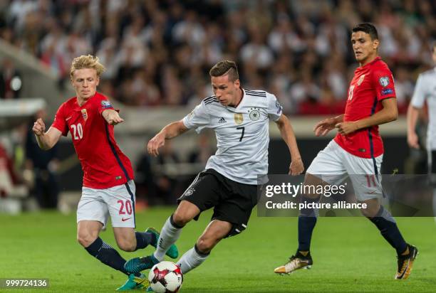 Germany's Julian Draxler and Norway's Haitam Aleesami and Mohamed Elyounoussi vie for the ball during the soccer World Cup qualification group stage...