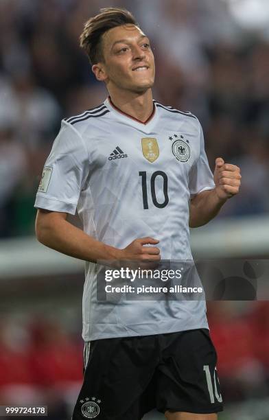 Germany's Mesut Oezil celebrates his goal for a 1:0 lead for his side during the soccer World Cup qualification group stage match between Germany and...