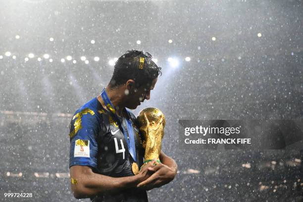 France's defender Raphael Varane holds the World Cup trophy after winning the Russia 2018 World Cup final football match between France and Croatia...